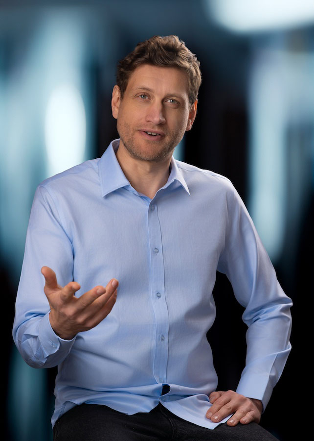 Web Designer Stefan Ehrenfeld talking with hand gesture.